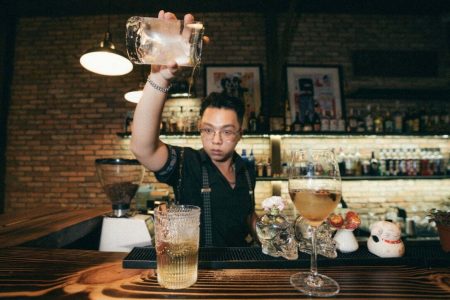 Expert bar tender preparing unique and exquisite cocktails for customers. Business for sale in Ho Chi Minh City.